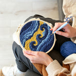 Creating handmade abstract blue and gold waves punch needle artwork