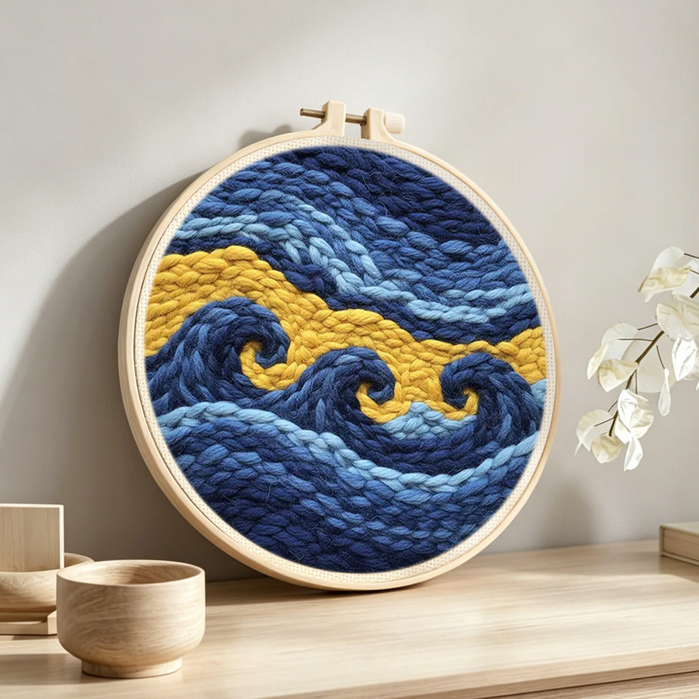 Abstract blue and gold waves punch needle artwork displayed on a table