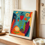 Abstract botanical garden punch needle artwork displayed on a table