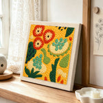 Abstract botanical pattern punch needle artwork displayed on a table