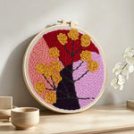 Abstract colour block tree with flowers punch needle artwork displayed on a table