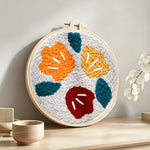 Abstract colourful flowers punch needle artwork displayed on a table