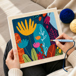 Creating handmade abstract floral with vibrant leaves punch needle artwork