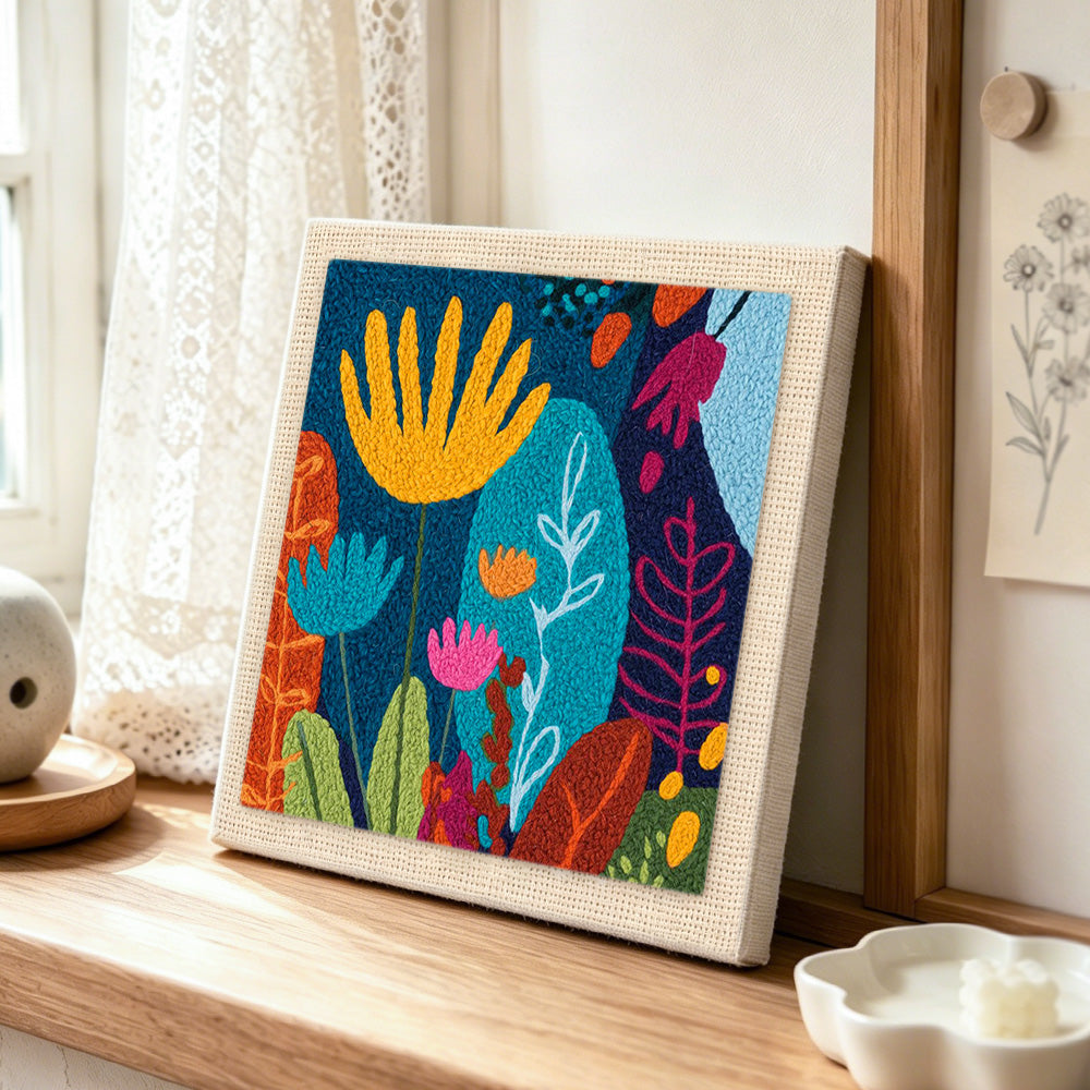 Abstract floral with vibrant leaves punch needle artwork displayed on a table