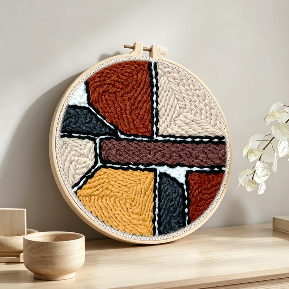 Abstract geometric colour blocks punch needle artwork displayed on a table