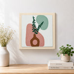 Finished abstract geometric vase artwork displayed on a wall