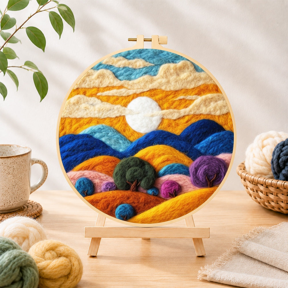 Finished abstract wavy clouds and colourful hills needle felting displayed on a wooden easel