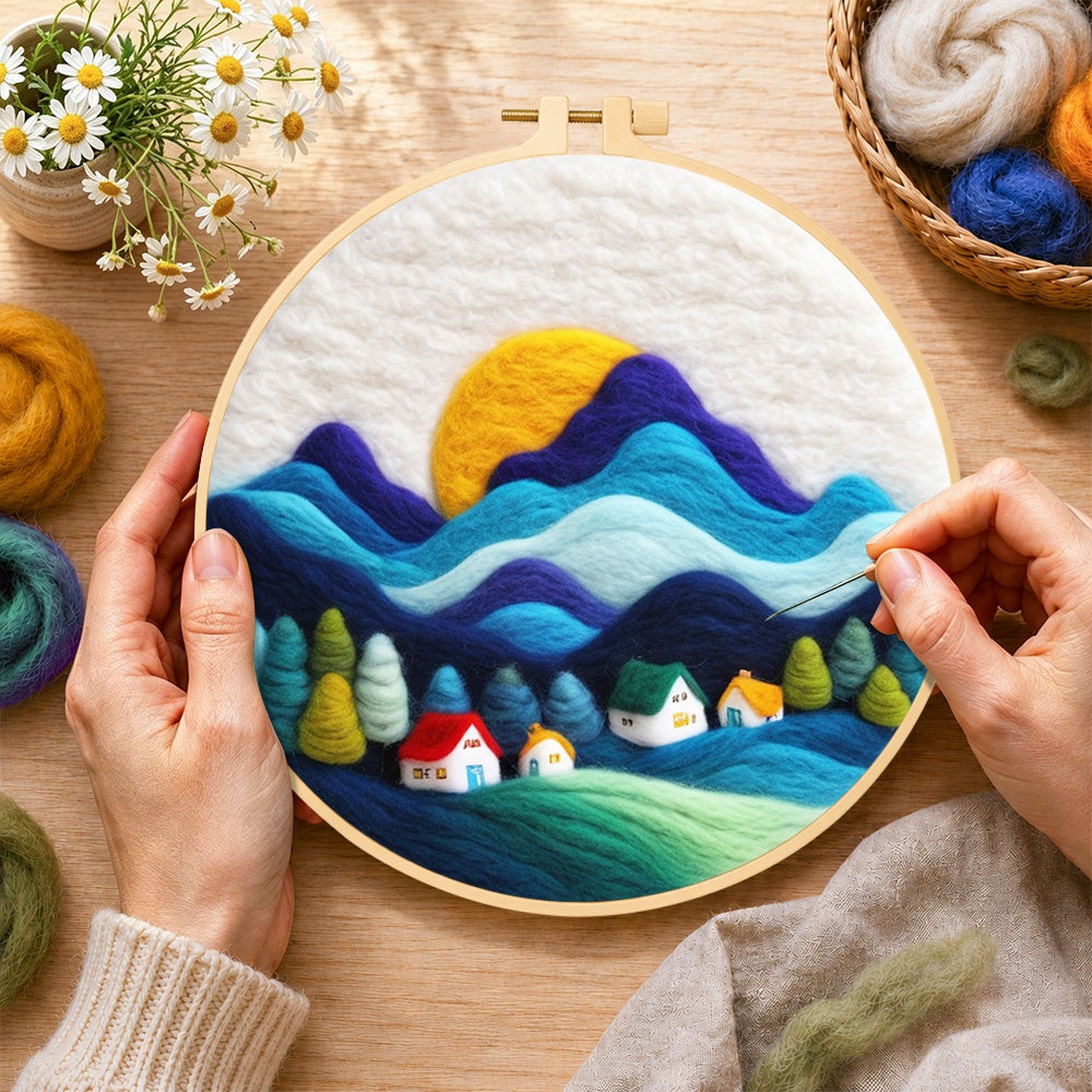 Creating the abstract wavy mountains and tiny houses wool painting by hand with a felting needle