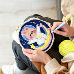 Creating handmade adorable astronaut bunny on rainbow moon punch needle artwork
