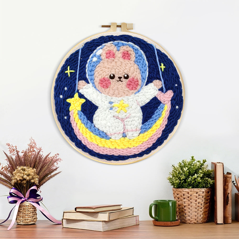 Finished adorable astronaut bunny on rainbow moon artwork displayed on a wall