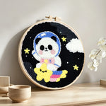 Adorable astronaut panda with star punch needle artwork displayed on a table