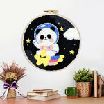 Finished adorable astronaut panda with star artwork displayed on a wall