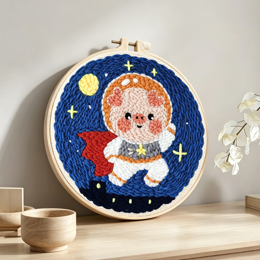 Adorable astronaut piggy punch needle artwork displayed on a table