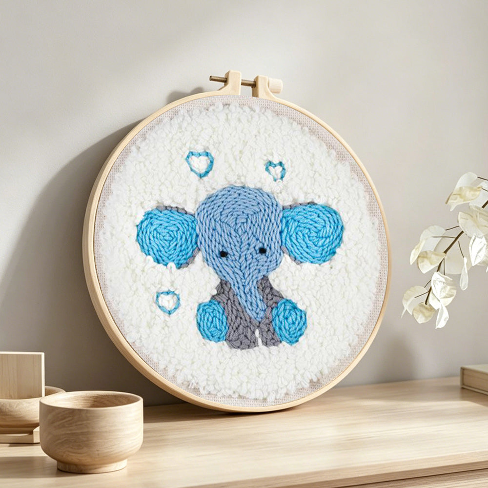 Adorable baby elephant punch needle artwork displayed on a table