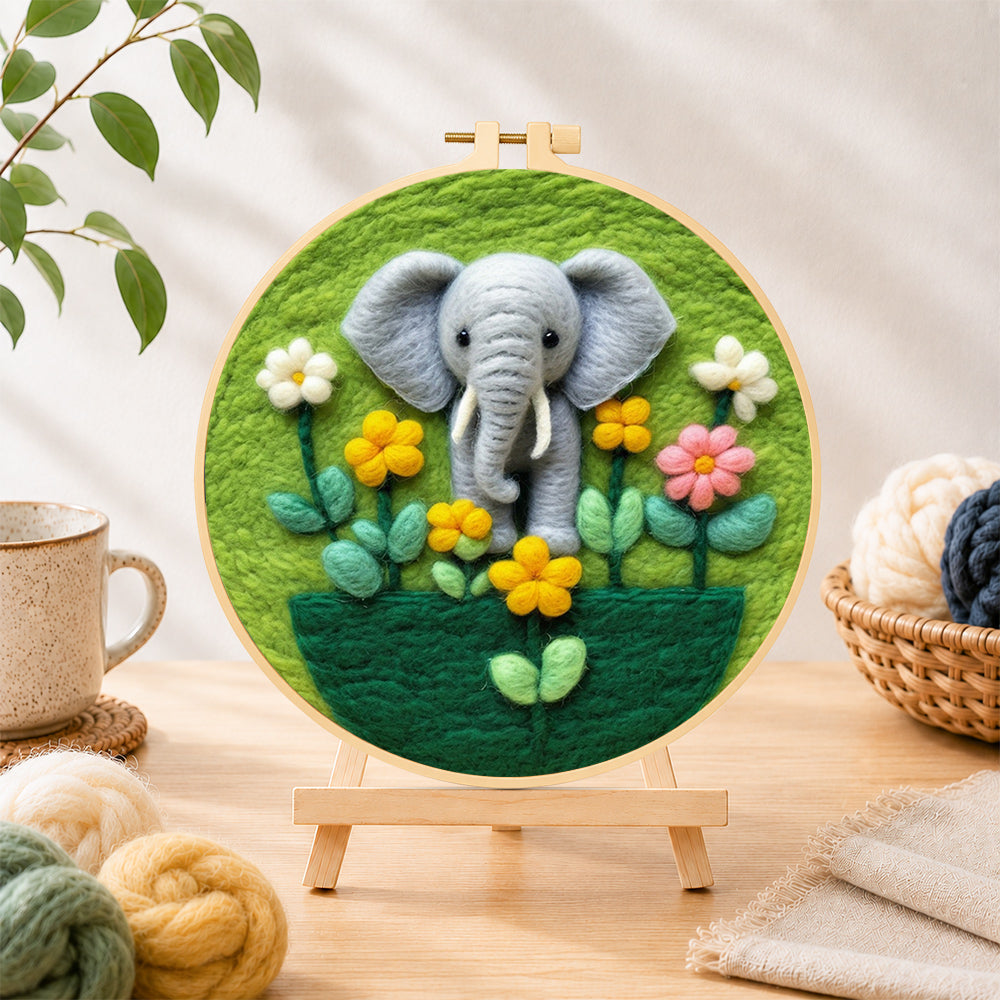 Finished adorable baby elephant with flowers needle felting displayed on a wooden easel