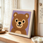 Adorable bear face punch needle artwork displayed on a table