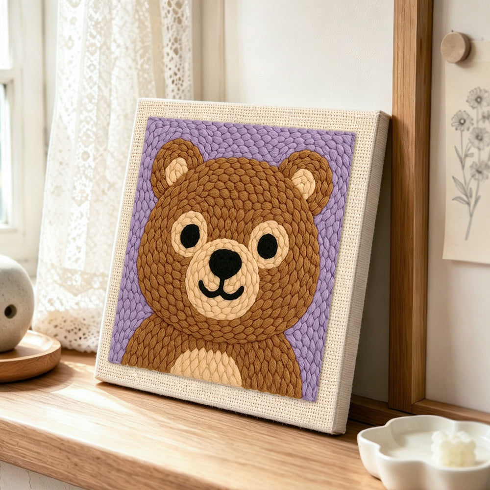 Adorable bear face punch needle artwork displayed on a table
