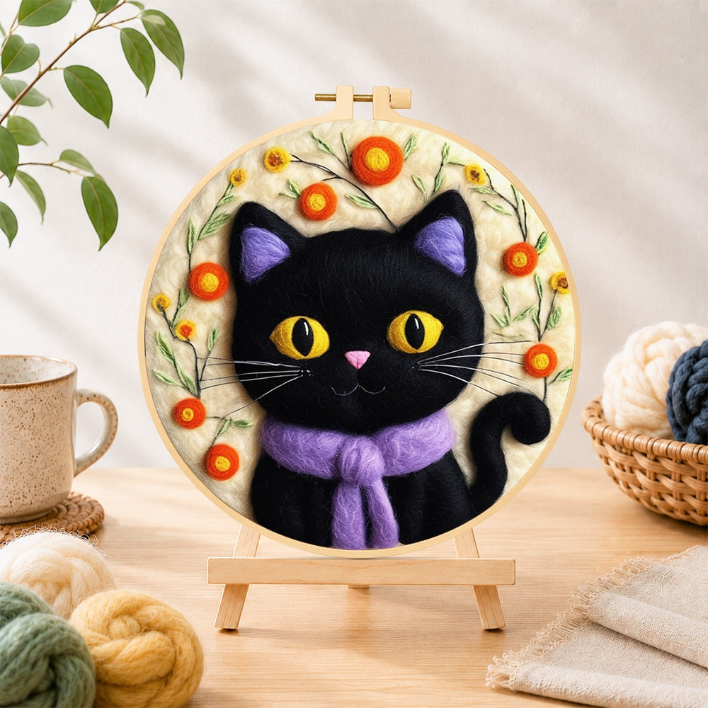 Finished adorable black cat with scarf needle felting displayed on a wooden easel
