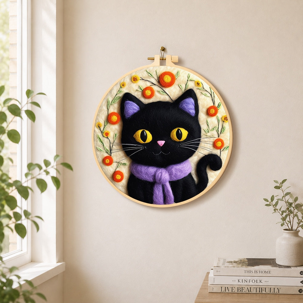 Adorable black cat with scarf needle felt wall art displayed in a bright home interior