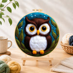 Finished adorable brown and white owl needle felting displayed on a wooden easel