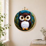 Adorable brown and white owl needle felt wall art displayed in a bright home interior