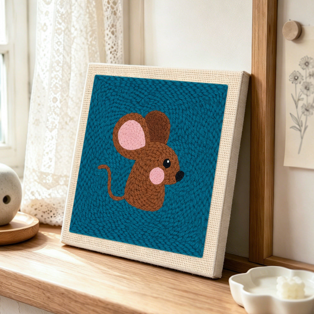 Adorable brown mouse punch needle artwork displayed on a table