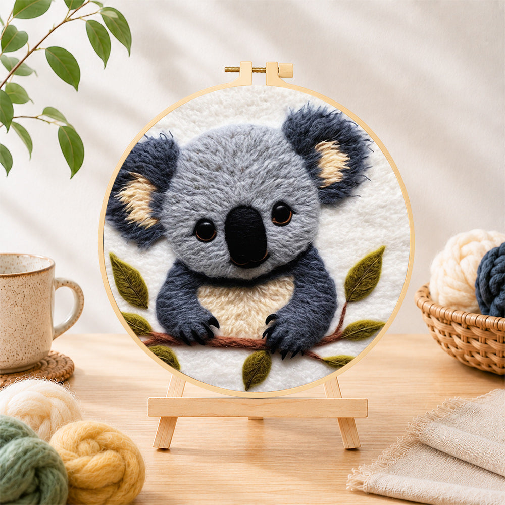 Finished adorable fluffy koala needle felting displayed on a wooden easel