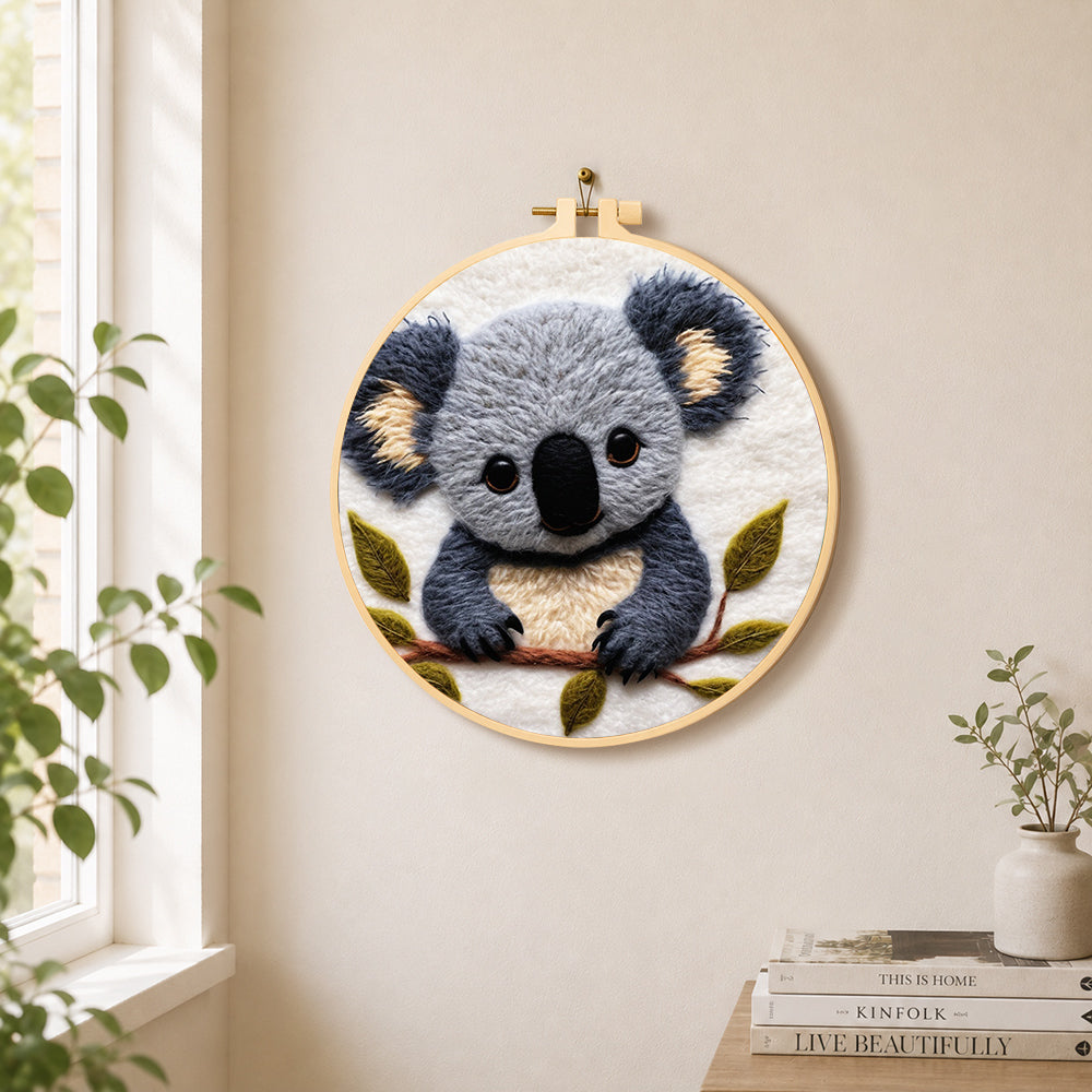 Adorable fluffy koala needle felt wall art displayed in a bright home interior