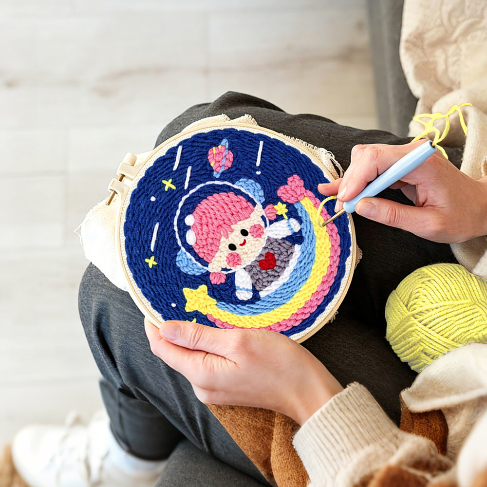 Creating handmade adorable girl astronaut on rainbow punch needle artwork