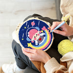 Creating handmade adorable girl astronaut on rainbow punch needle artwork