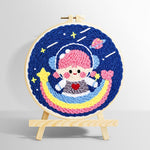 Adorable girl astronaut on rainbow punch needle kit for beginners