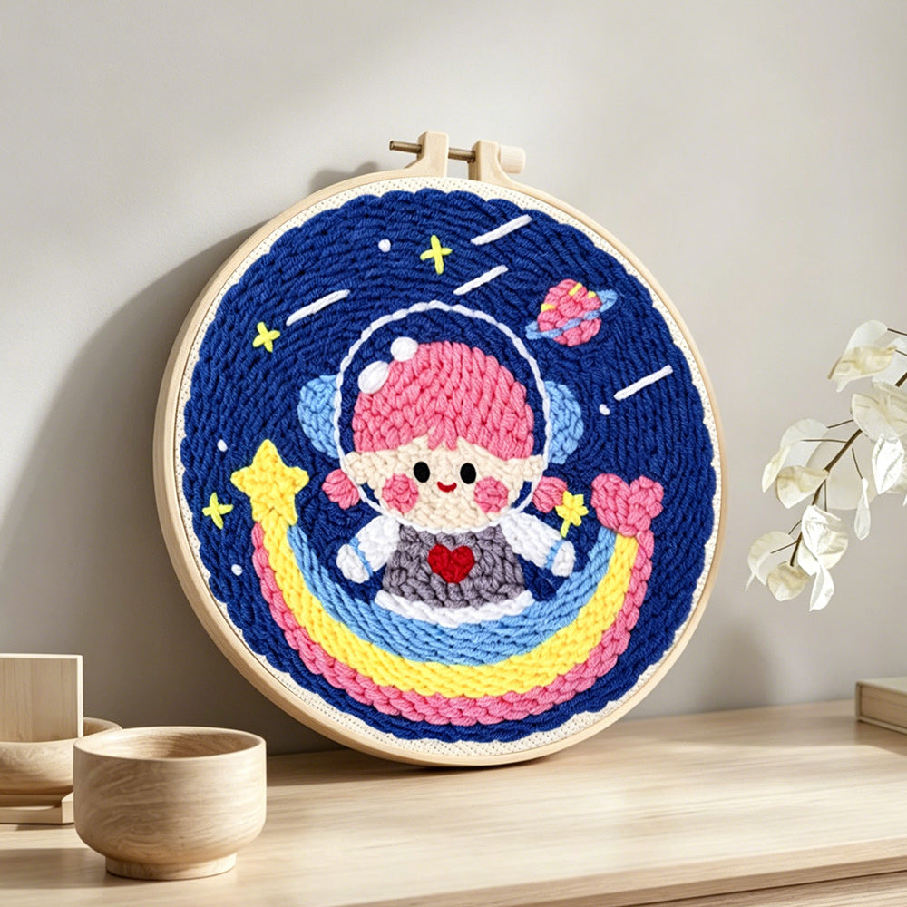 Adorable girl astronaut on rainbow punch needle artwork displayed on a table