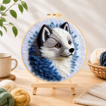 Finished adorable grey wolf needle felting displayed on a wooden easel