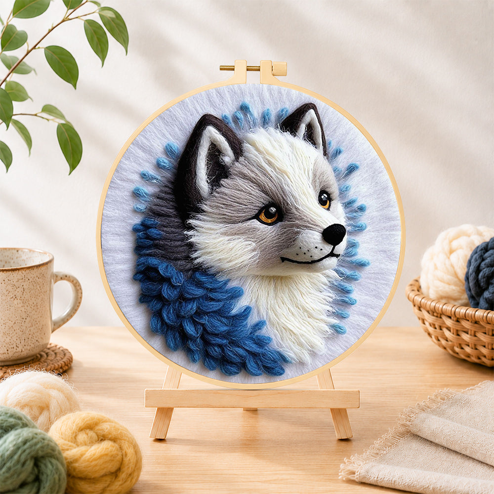 Finished adorable grey wolf needle felting displayed on a wooden easel