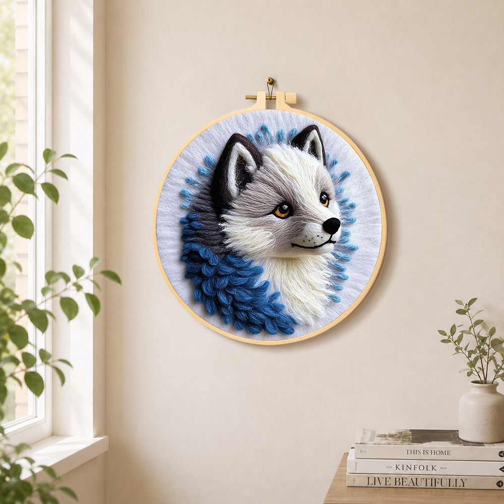 Adorable grey wolf needle felt wall art displayed in a bright home interior