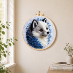 Adorable grey wolf needle felt wall art displayed in a bright home interior
