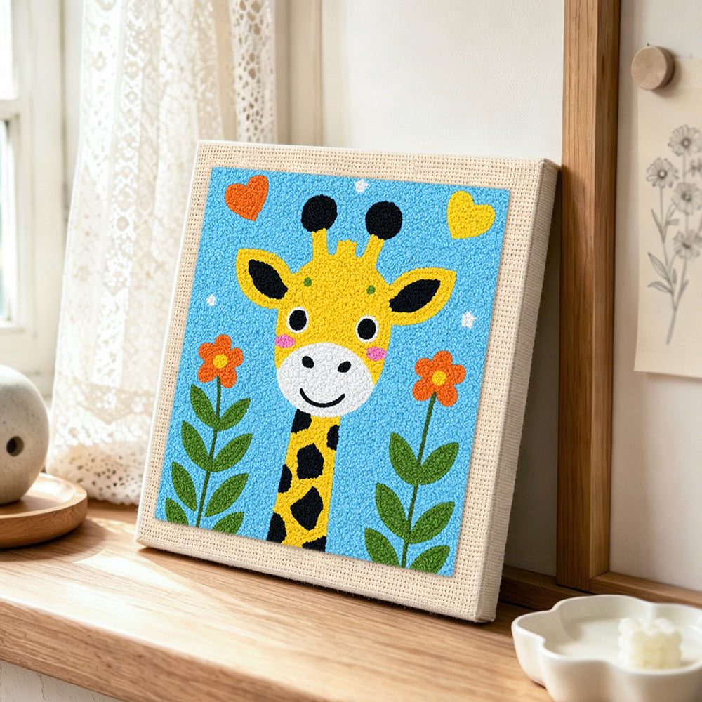 Adorable love-themed giraffe punch needle artwork displayed on a table