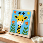 Adorable love-themed giraffe punch needle artwork displayed on a table