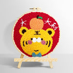 Adorable lucky tiger with an orange punch needle kit for beginners