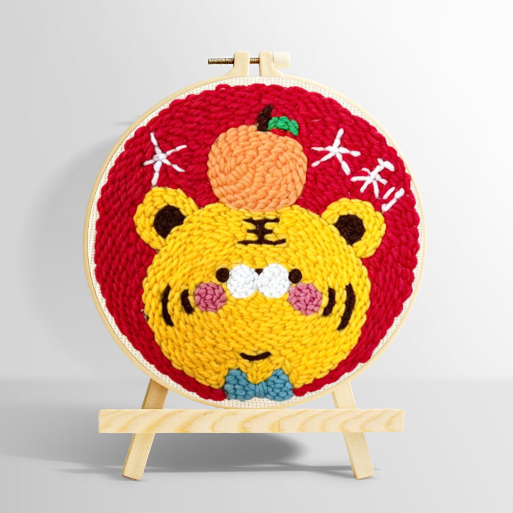 Adorable lucky tiger with an orange punch needle kit for beginners