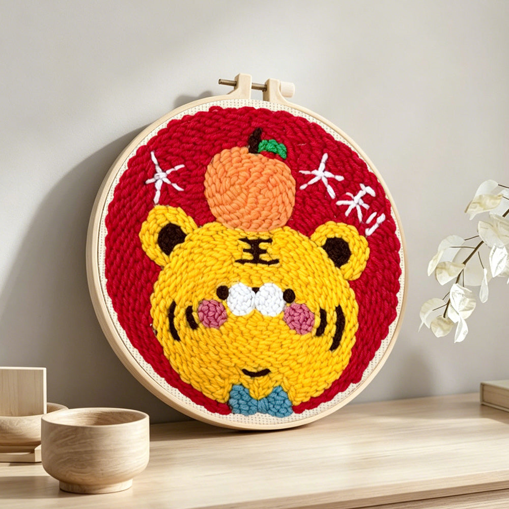 Adorable lucky tiger with an orange punch needle artwork displayed on a table