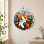 Adorable orange and white kitten needle felt wall art displayed in a bright home interior