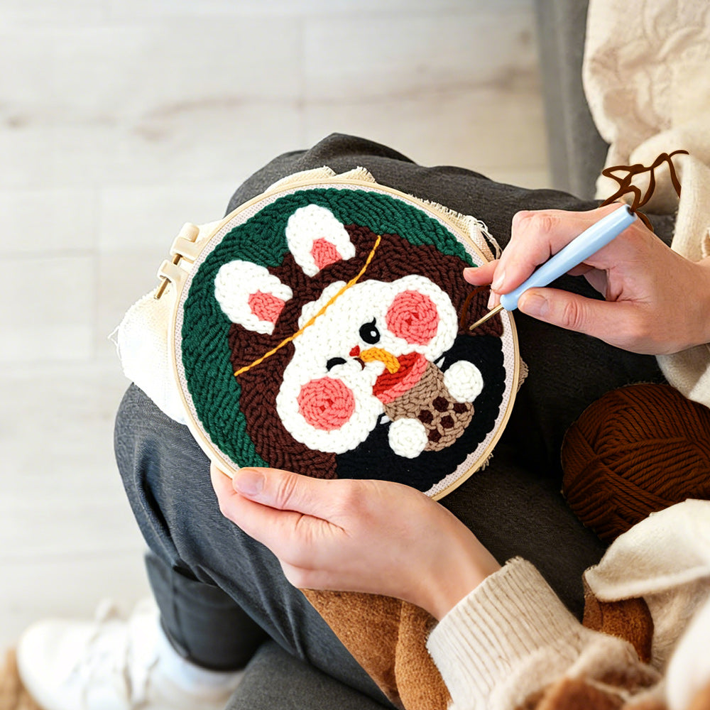 Creating handmade adorable rabbit drinking bubble tea punch needle artwork