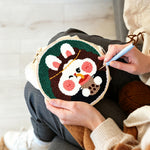 Creating handmade adorable rabbit drinking bubble tea punch needle artwork