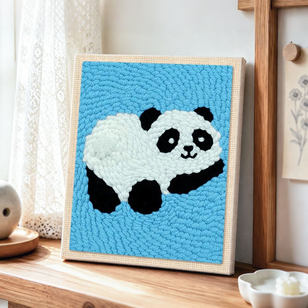Adorable relaxing panda punch needle artwork displayed on a table