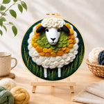 Finished adorable sheep and green grass needle felting displayed on a wooden easel