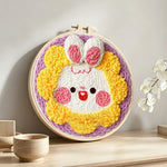Adorable sunflower bunny punch needle artwork displayed on a table