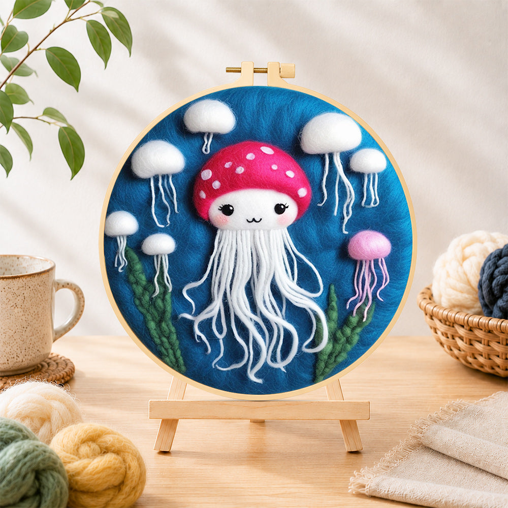 Finished adorable white jellyfish needle felting displayed on a wooden easel