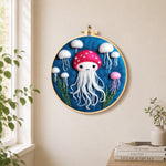 Adorable white jellyfish needle felt wall art displayed in a bright home interior