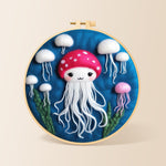 Adorable white jellyfish needle felting kit for beginners with a round wooden frame